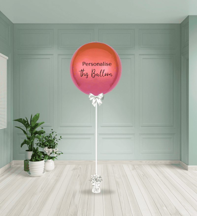 a large pink and orange balloon in a room with plants