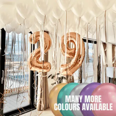 Elegant room filled with white ceiling balloons and large number 25 balloons in rose gold, with text 'Many more colours available' and a palette of balloons in various colours.