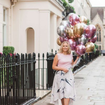 Woman carrying luxury balloon gifts in London