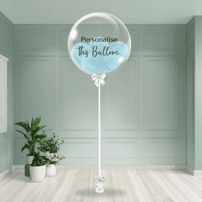 A gentle baby blue bubble balloon on a stand, ready to be personalised, offers a serene touch.