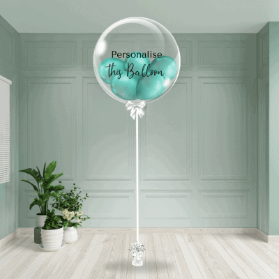 Green chrome bubble balloon with a personalised touch, anchored in a chic setting.