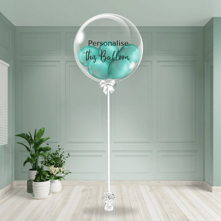 Green chrome bubble balloon with a personalised touch, anchored in a chic setting.