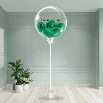 A lush green bubble balloon stands with an option for personalisation, set in a calm and elegant room.