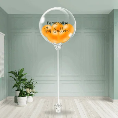 An orange bubble balloon stands ready to be customised, bringing a burst of warmth to the decor.