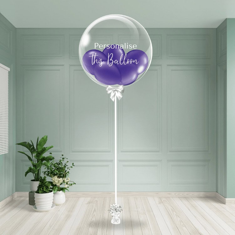 A purple bubble balloon ready for personalisation stands out in a neutral-toned room.