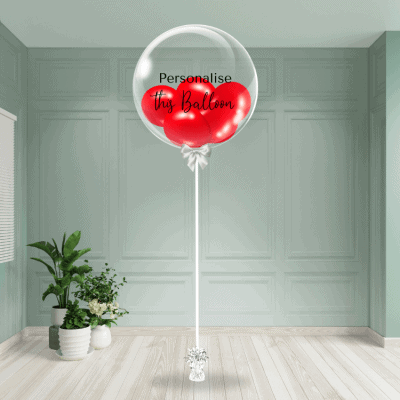 A striking red bubble balloon with customisation capabilities stands tall, creating a focal point in the room.