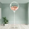Personalised rose gold chrome bubble balloon tied with a sleek white ribbon in a stylish interior.