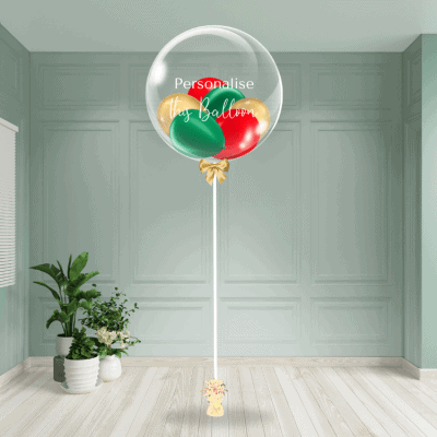 Festive bubble balloon in traditional Christmas colours with customisable text, on a decorative stand.
