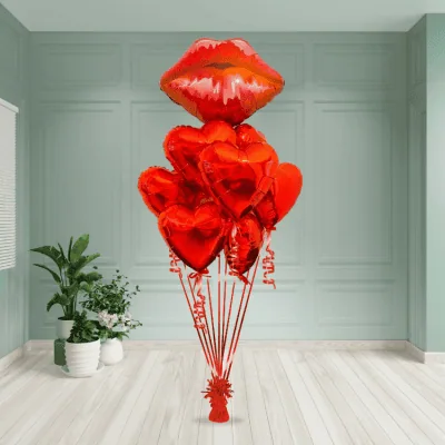 Striking bouquet of red heart balloons topped with a large lip-shaped balloon, ideal for Valentine's Day in London