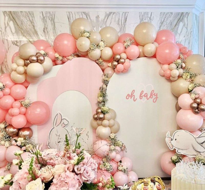 a pink and white balloon arch