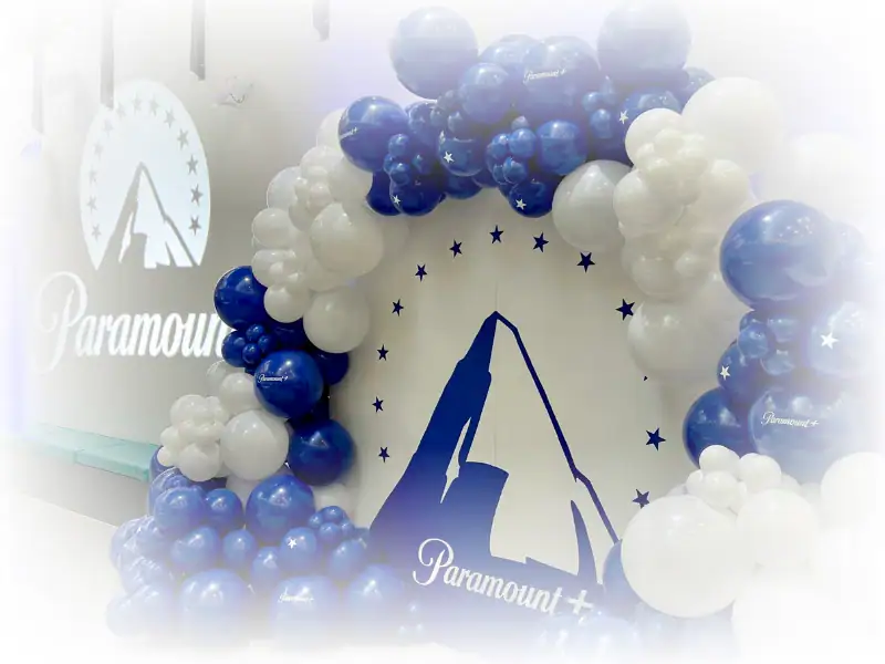 Blue and white Paramount+ branded balloon arch for corporate film launch event.