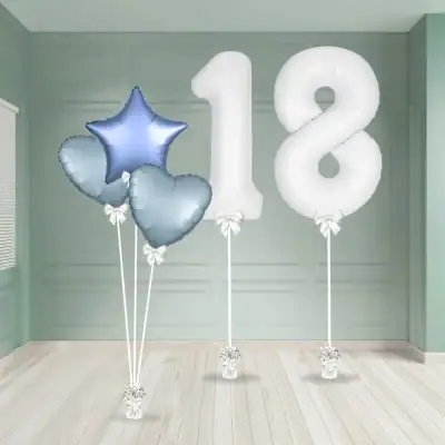 White number 18 foil balloons with metallic blue star and heart foils styled with ribbons and weights