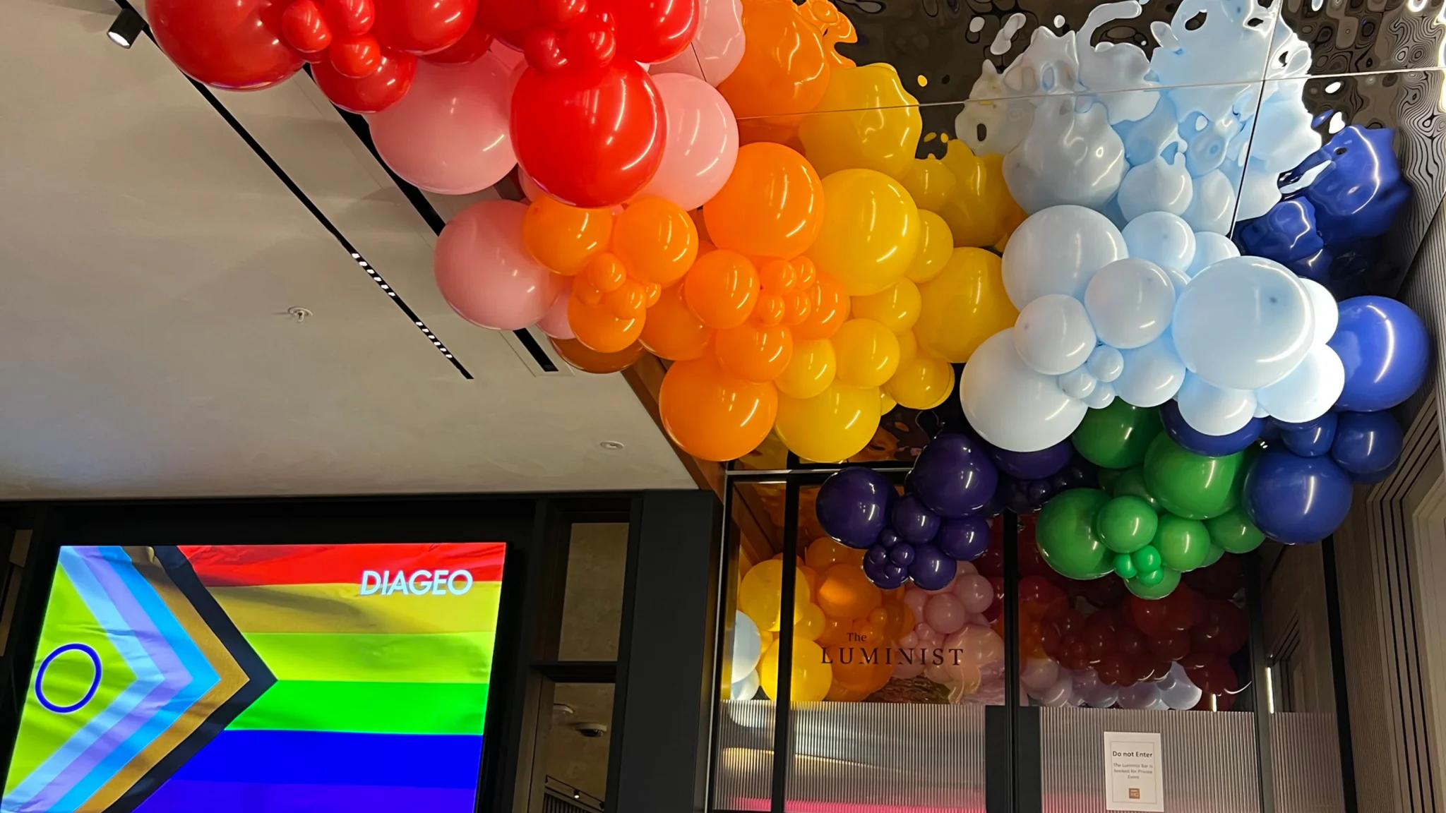 Rainbow balloon ceiling installation for Diageo Pride event